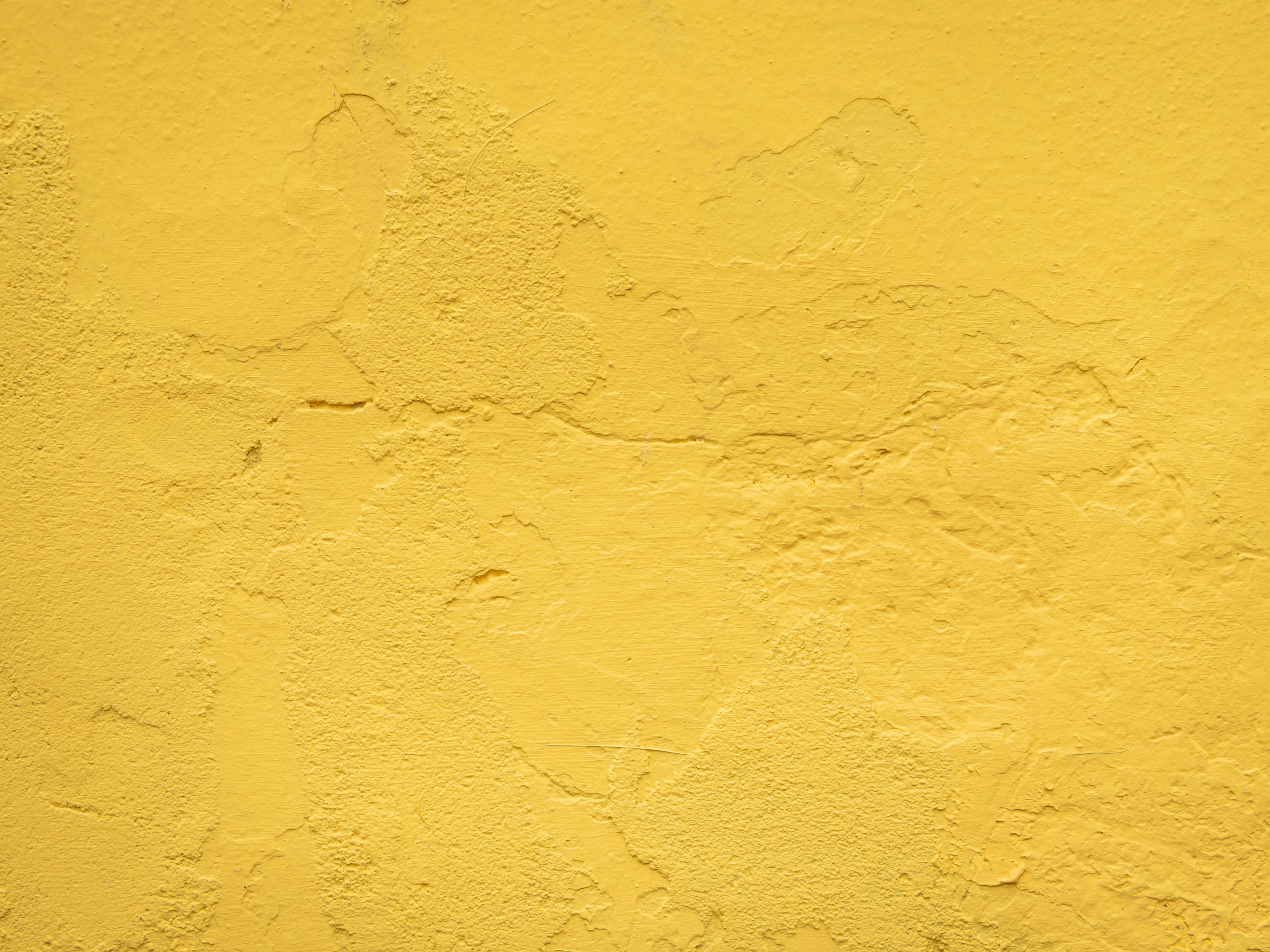 Mustard yellow cement wall background.